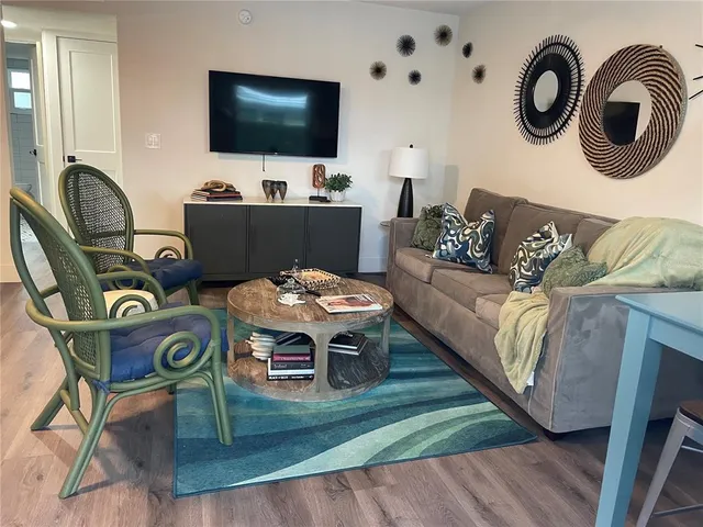 a living room with furniture and wooden floor