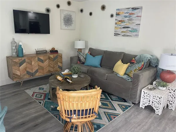 a living room with furniture and wooden floor