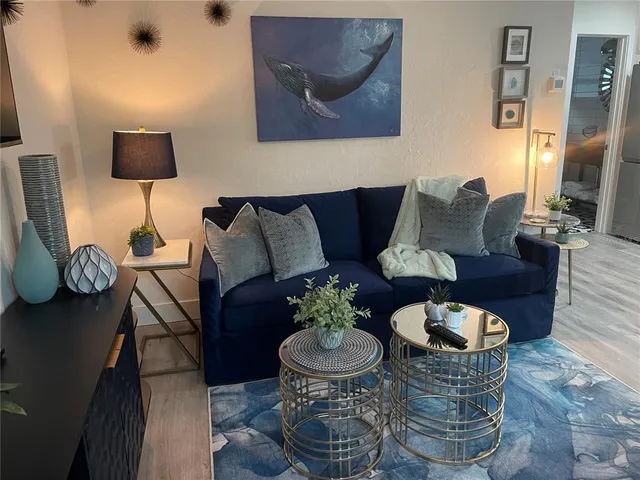 a kitchen with granite countertop a sink a stove and cabinets