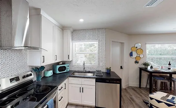 a kitchen with a refrigerator and a stove top oven