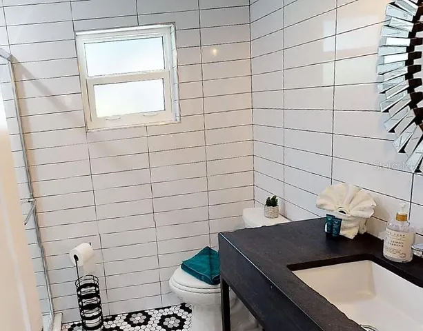 a bedroom with a bed and painting on the wall