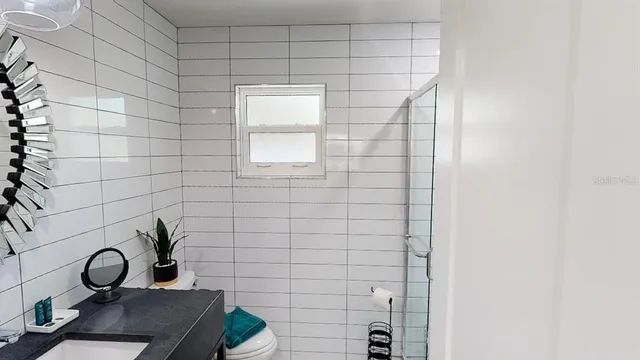 a bed sitting in a bedroom next to a lamp