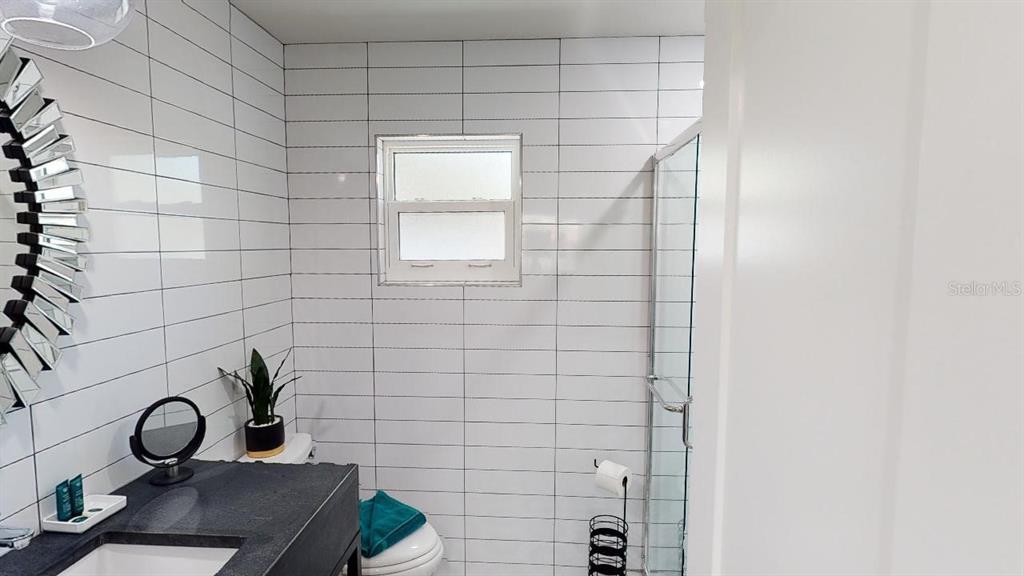 1912 Morrill Street, Unit LIME Sarasota, FL 34236 - Photo 31 of 34 a bathroom with a sink and a mirror