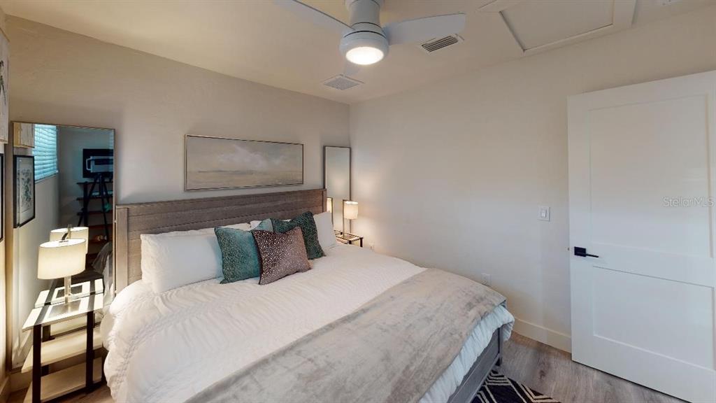1912 Morrill Street, Unit LIME Sarasota, FL 34236 - Photo 32 of 34 a bedroom with a bed and painting on the wall