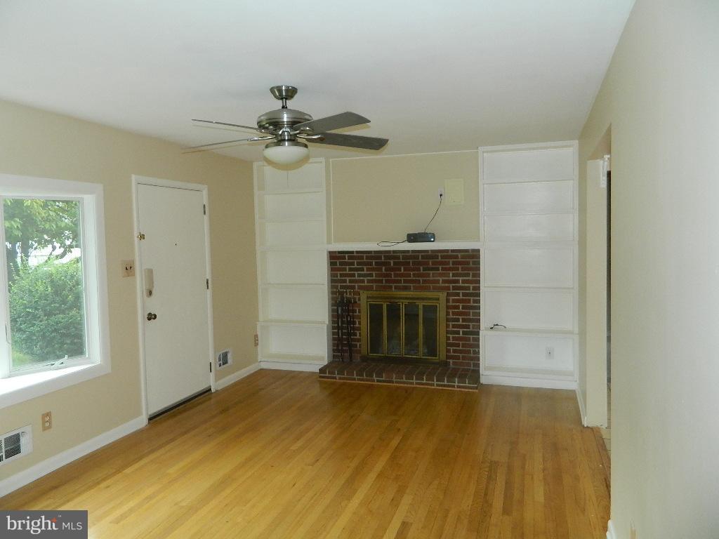 1252 Beach Road Edgewater, MD 21037 - Photo 2 of 20 Living Room with hardwood floors and fireplace