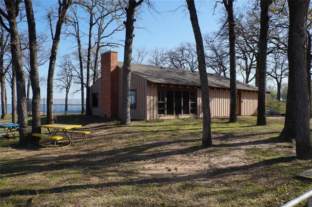 a view of a house with a tree in front