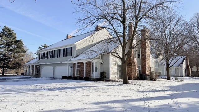 a front view of a house with a snow in front of it