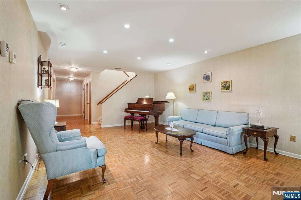 29 Ponds Circle, Unit 15 Wayne, NJ 07470 - Photo 11 of 47 a living room with furniture and a wooden floor