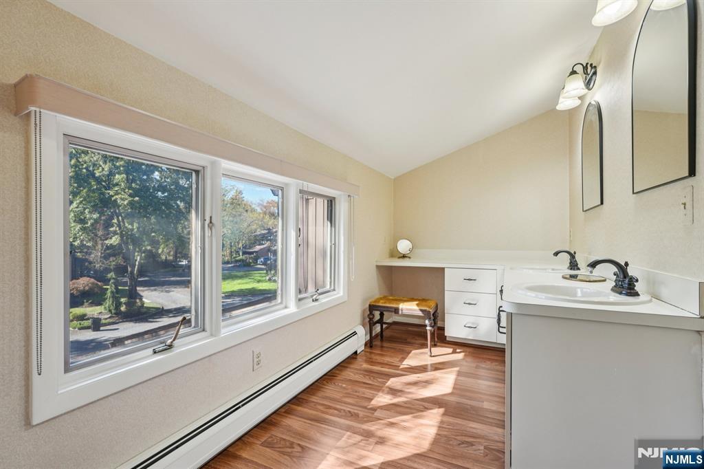 29 Ponds Circle, Unit 15 Wayne, NJ 07470 - Photo 29 of 47 a spacious bathroom with a double vanity sink and a large mirror