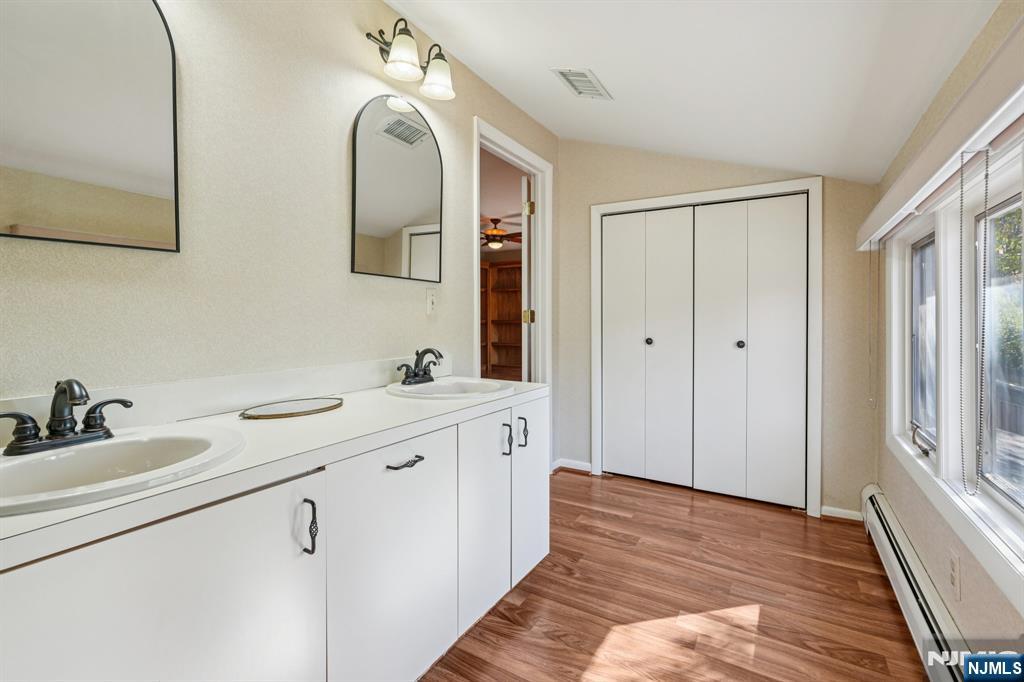 29 Ponds Circle, Unit 15 Wayne, NJ 07470 - Photo 30 of 47 a spacious bathroom with a double vanity sink and mirror