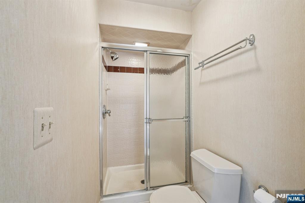 29 Ponds Circle, Unit 15 Wayne, NJ 07470 - Photo 31 of 47 a bathroom with a shower a toilet and a shower