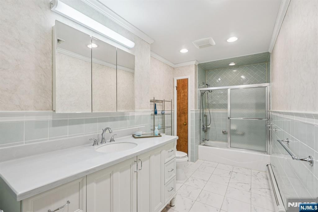 29 Ponds Circle, Unit 15 Wayne, NJ 07470 - Photo 34 of 47 a bathroom with a shower sink and mirror