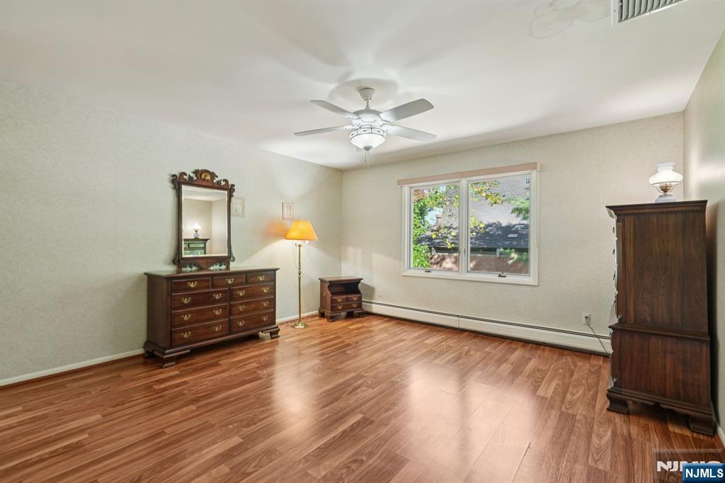 29 Ponds Circle, Unit 15 Wayne, NJ 07470 - Photo 36 of 47 wooden floor in an empty room with a window
