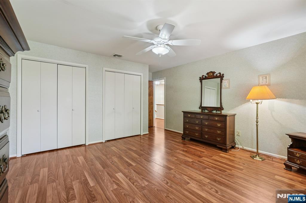29 Ponds Circle, Unit 15 Wayne, NJ 07470 - Photo 37 of 47 a view of a room with wooden floor closet and a chandelier
