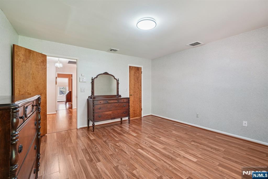 29 Ponds Circle, Unit 15 Wayne, NJ 07470 - Photo 39 of 47 a room with wooden floor and furniture