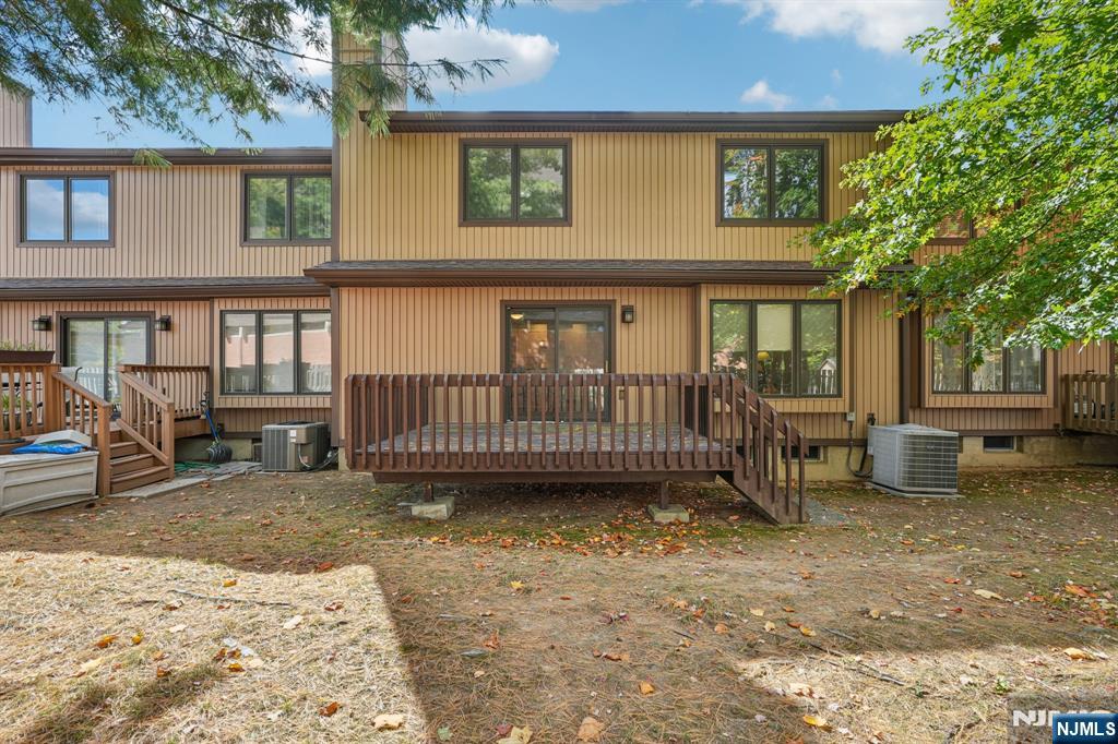 29 Ponds Circle, Unit 15 Wayne, NJ 07470 - Photo 45 of 47 a view of a house with a wooden deck and a yard