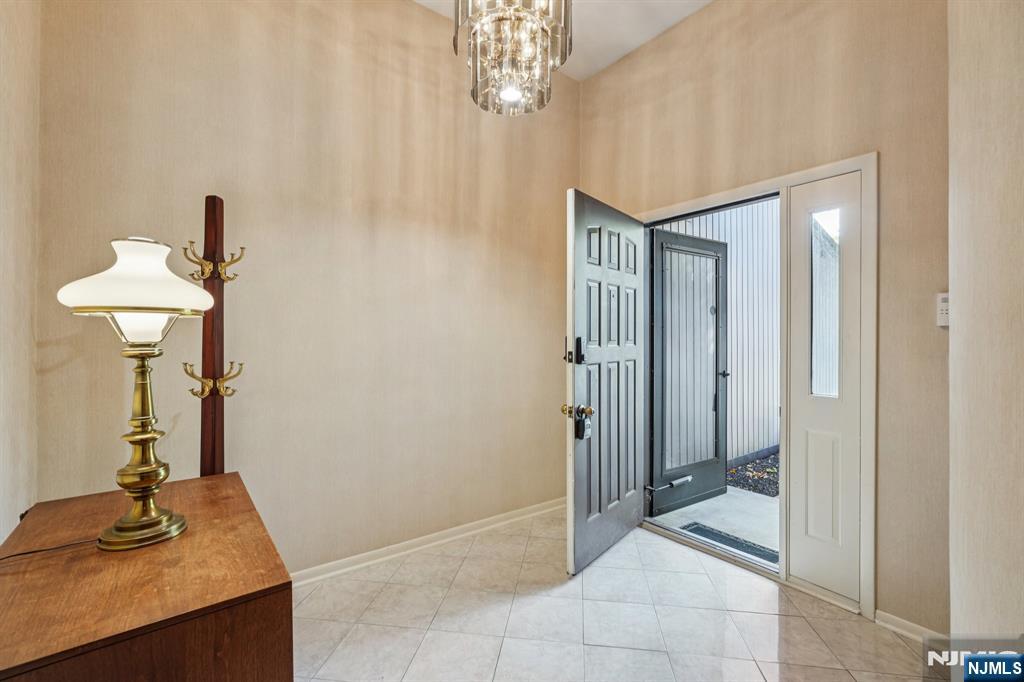 29 Ponds Circle, Unit 15 Wayne, NJ 07470 - Photo 6 of 47 a view of a hallway with a chandelier