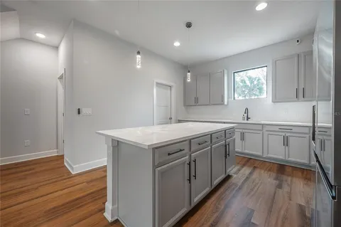 a kitchen with a sink window and cabinets