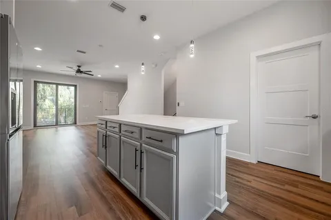 a view of a kitchen with a sink and wooden floor
