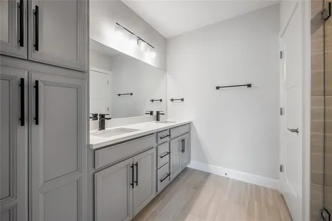 a bathroom with a double vanity sink and mirror