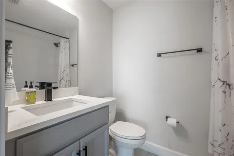 a bathroom with a sink toilet and mirror