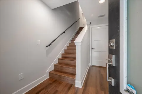 a view of entryway with wooden floor and stairs