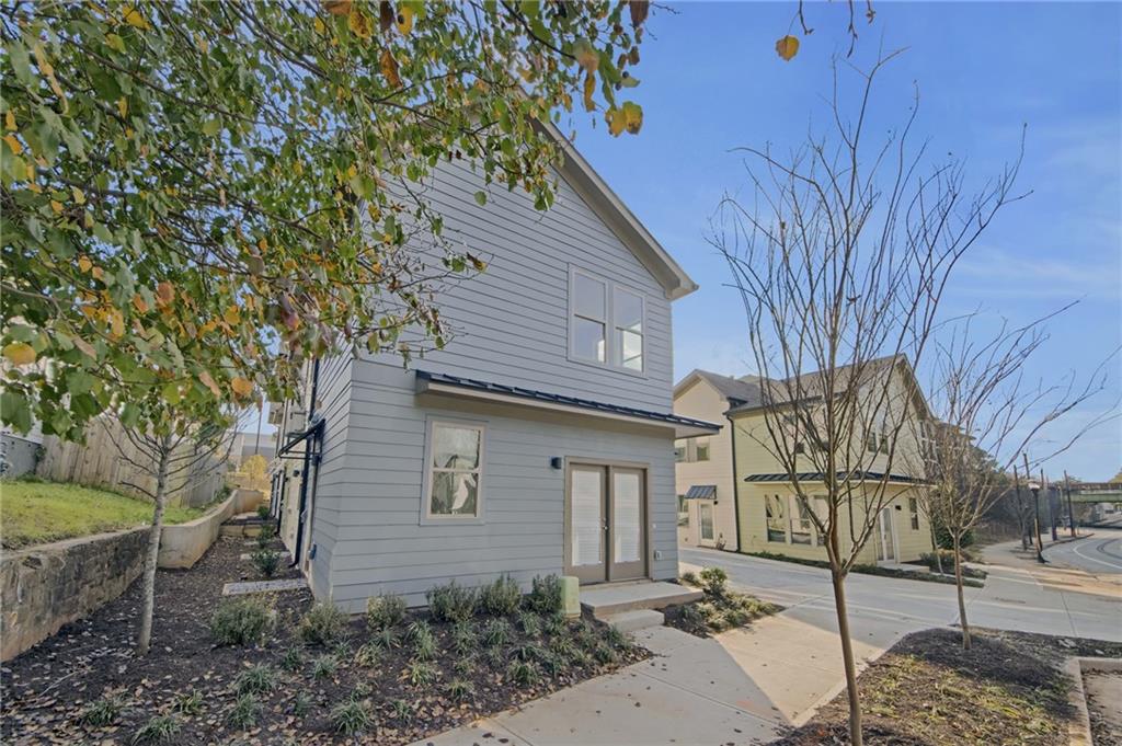 1070 Dill Avenue Southwest, Unit 103 Atlanta, GA 30310 - Photo 2 of 18 a front view of a house with garden