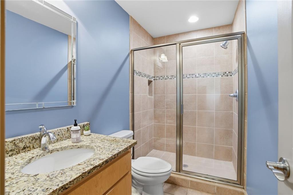 3326 Monument Road Jasper, GA 30143 - Photo 25 of 49 a bathroom with a granite countertop sink toilet and shower
