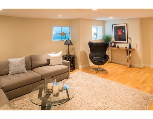 21 Sunset Road Marblehead, MA 01945 - Photo 15 of 21 a living room with furniture a flat screen tv and a floor to ceiling window