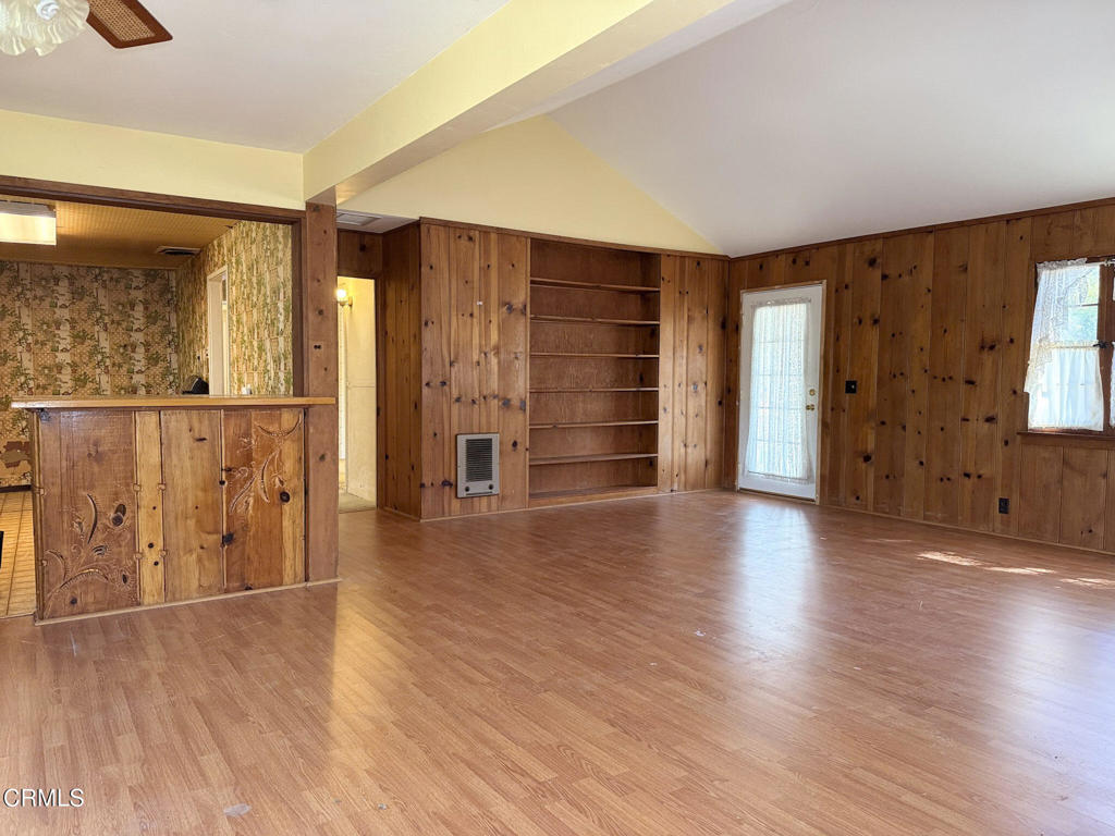 561 Tico Road Ojai, CA 93023 - Photo 11 of 59 an empty room with wooden floor and windows