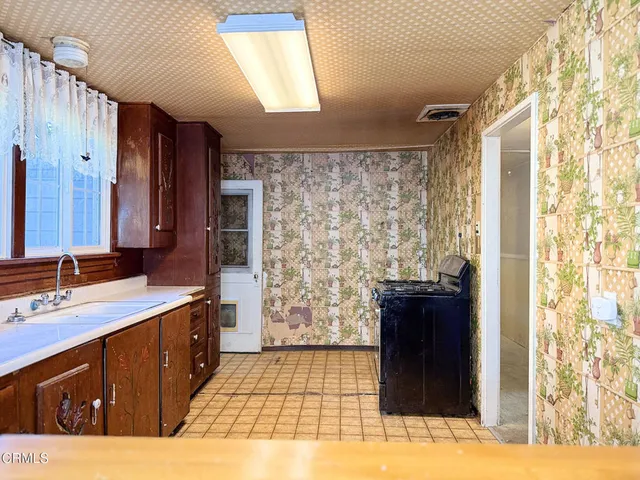 a kitchen with a sink and a refrigerator