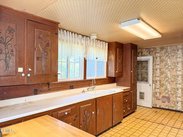 a bathroom with a double vanity sink large mirror and a bathtub