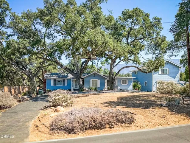 a front view of a house with a yard covered in snow
