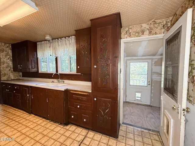 a living room with furniture a fireplace and a window