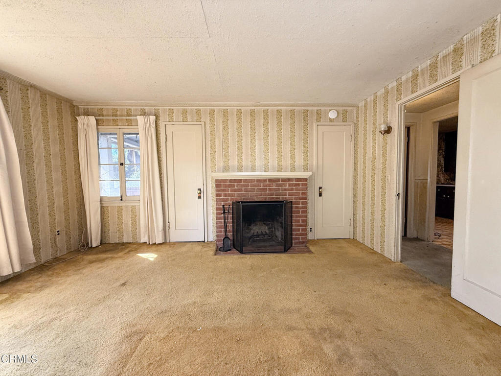 561 Tico Road Ojai, CA 93023 - Photo 28 of 59 an empty room with windows and fireplace