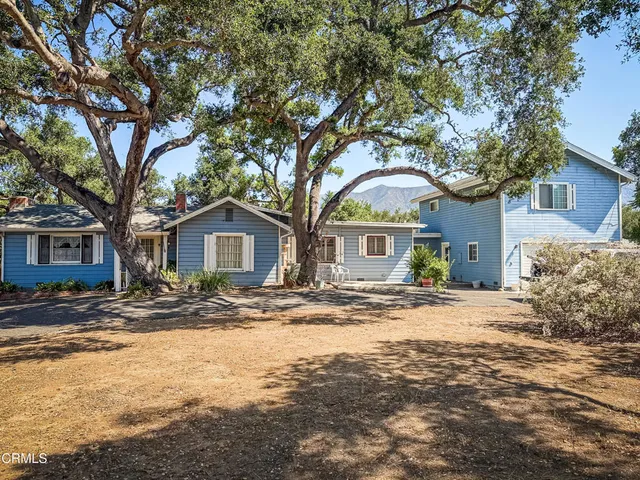 a front view of a house with a trees