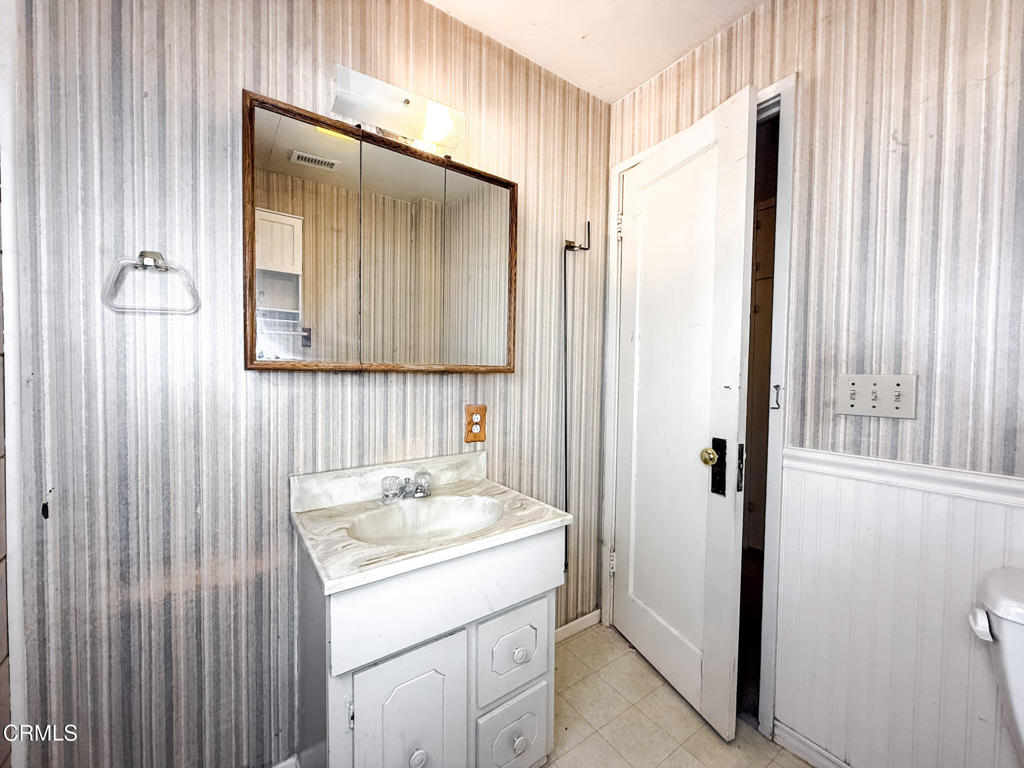 561 Tico Road Ojai, CA 93023 - Photo 31 of 59 a bathroom with a sink a vanity and a mirror
