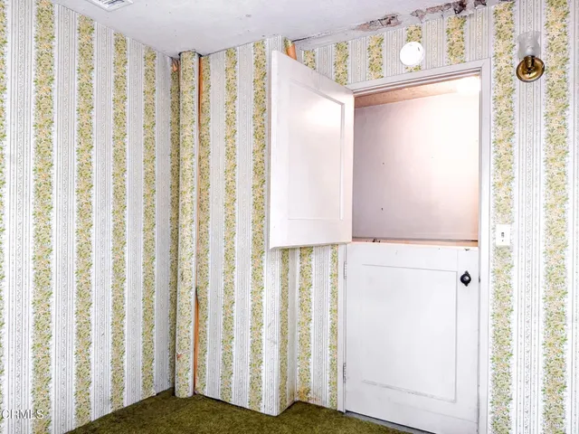 a bathroom with a sink and mirror with bathtub