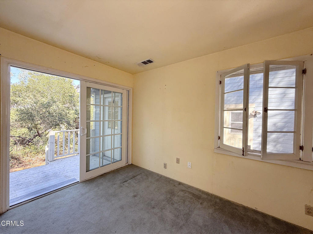 561 Tico Road Ojai, CA 93023 - Photo 39 of 59 an empty room with wooden floor and windows