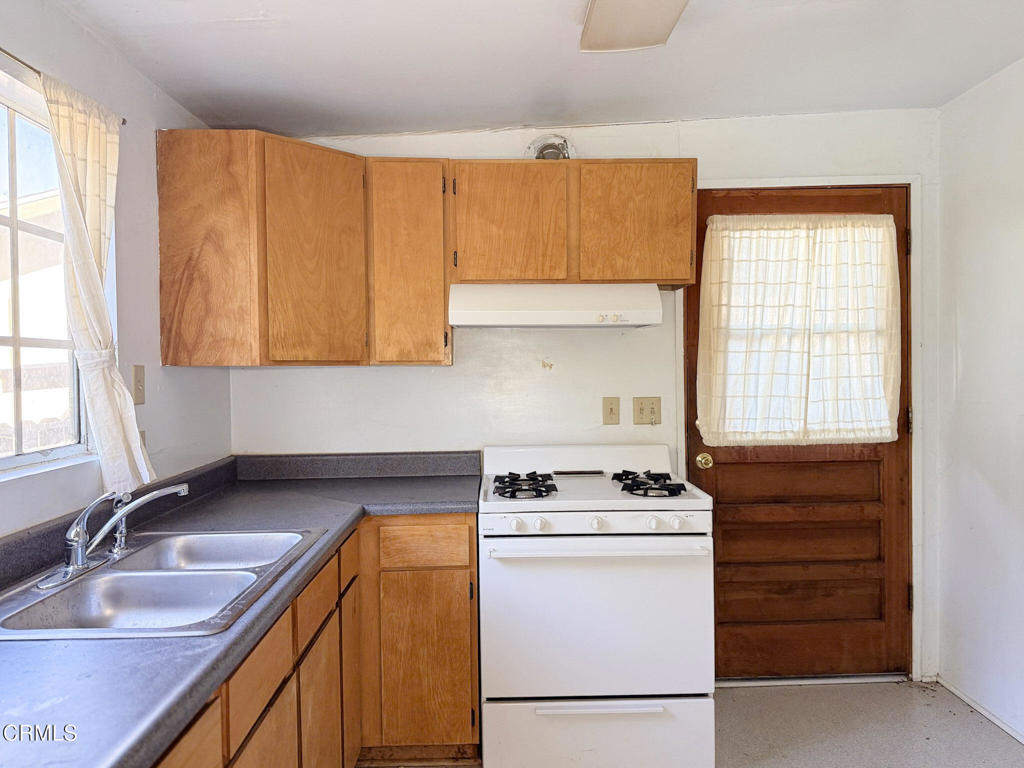 561 Tico Road Ojai, CA 93023 - Photo 46 of 59 a kitchen with a sink stove and cabinets