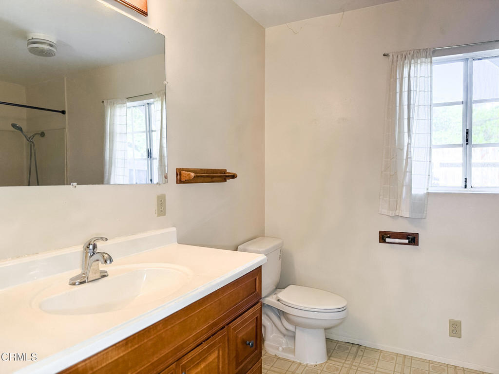 561 Tico Road Ojai, CA 93023 - Photo 49 of 59 a bathroom with a sink a toilet and mirror