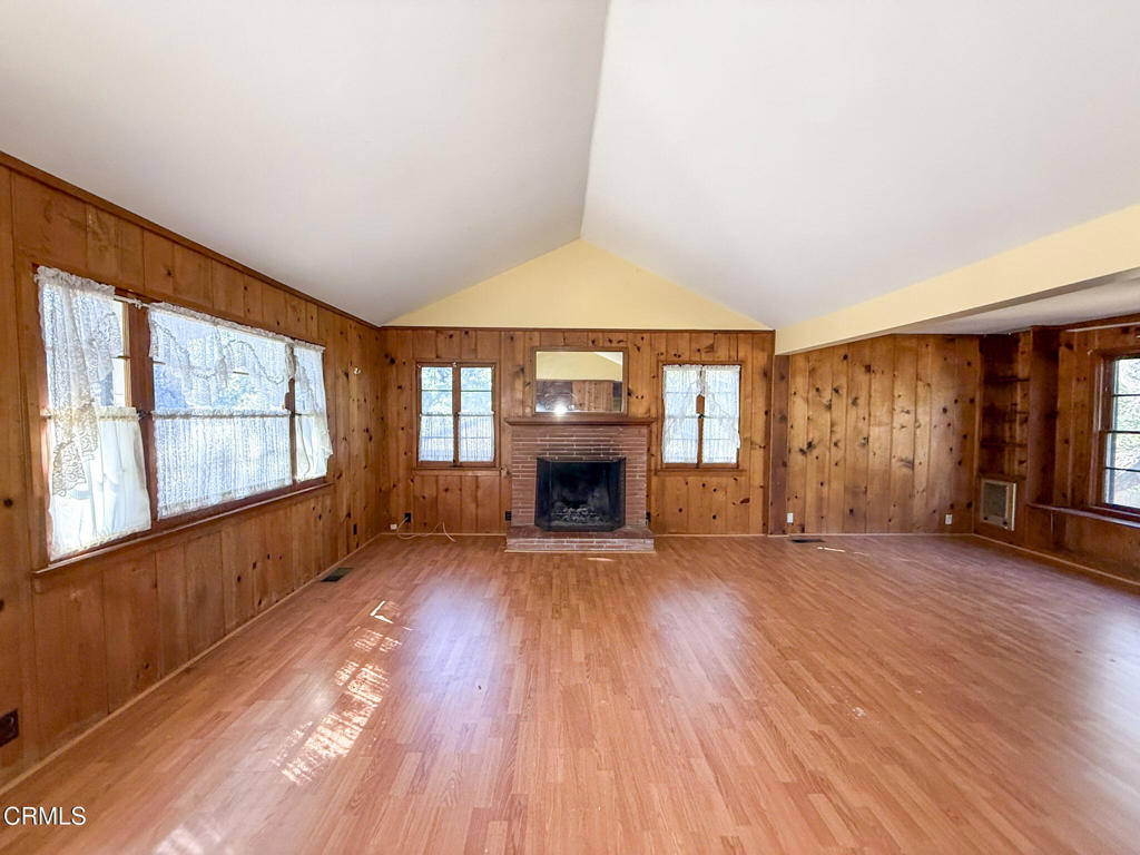 561 Tico Road Ojai, CA 93023 - Photo 7 of 59 wooden floor fireplace and windows in an empty room