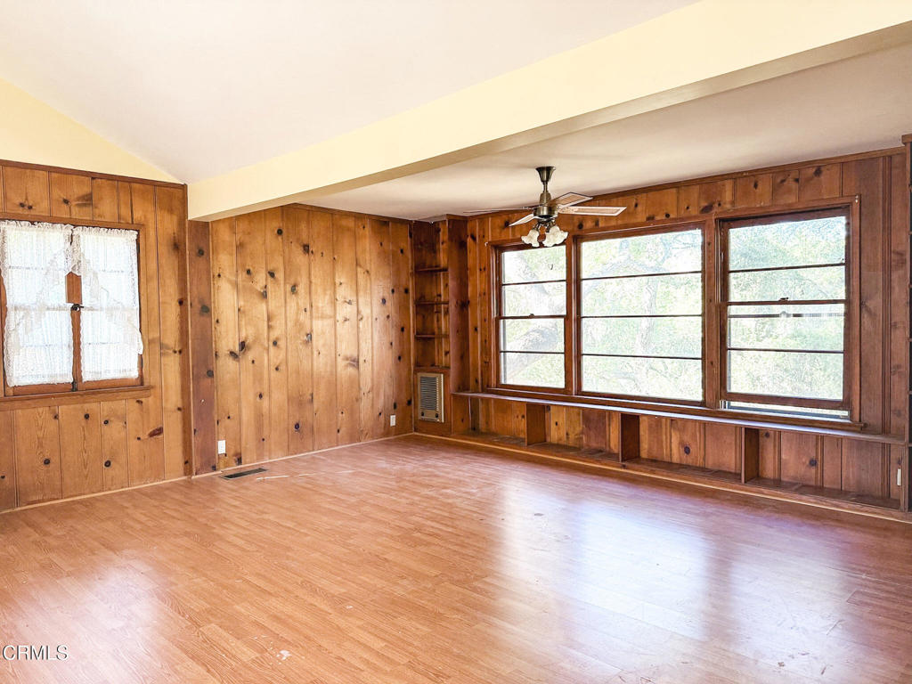 561 Tico Road Ojai, CA 93023 - Photo 10 of 59 an empty room with wooden floor and windows