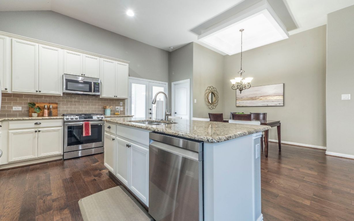 105 Penna Lane Georgetown, TX 78628 - Photo 11 of 39 a kitchen with a sink cabinets and wooden floor