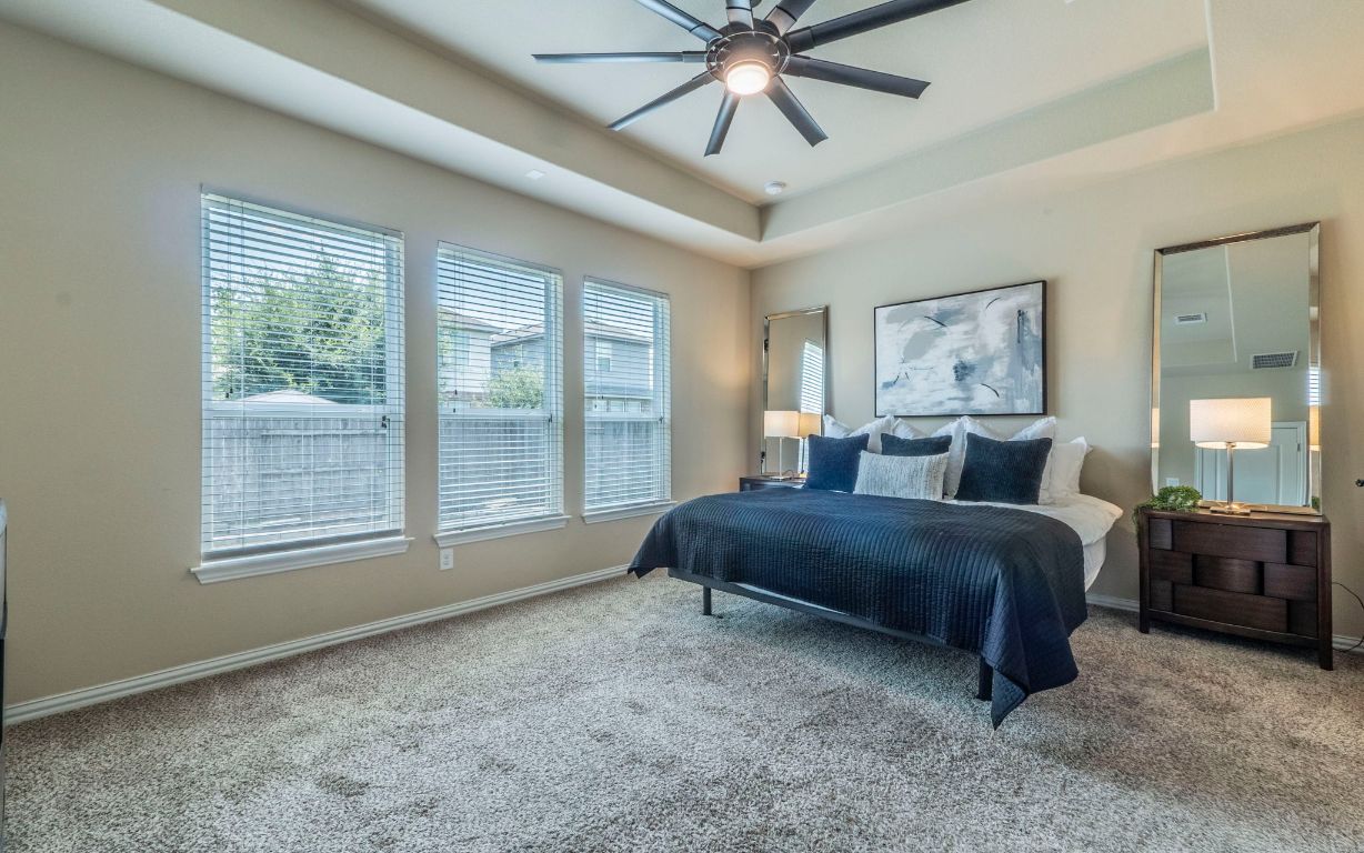 105 Penna Lane Georgetown, TX 78628 - Photo 14 of 39 a spacious bedroom with a large bed and a window