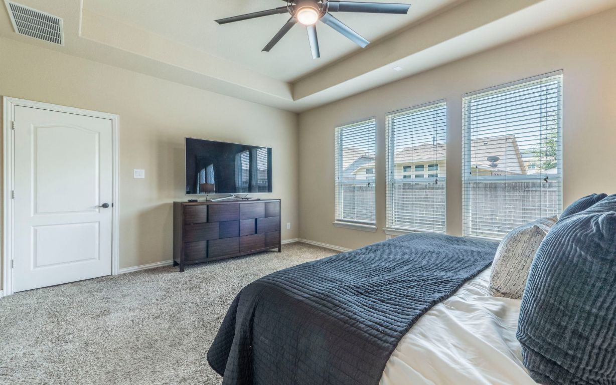 105 Penna Lane Georgetown, TX 78628 - Photo 16 of 39 a bedroom with a bed dresser and a large window