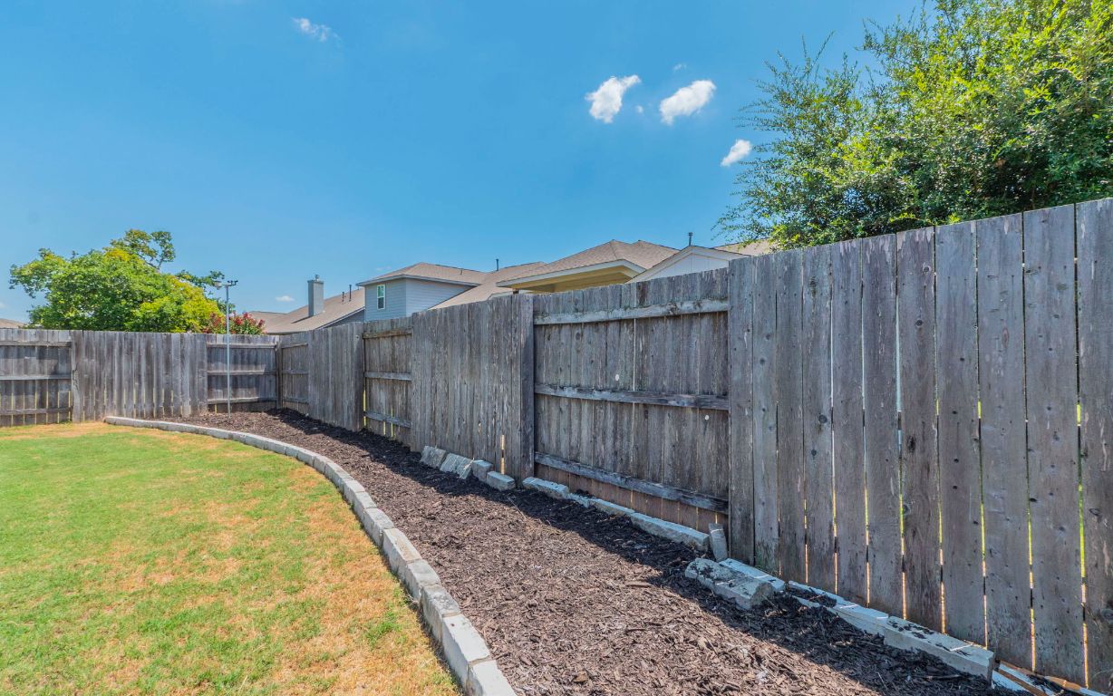 105 Penna Lane Georgetown, TX 78628 - Photo 30 of 39 a view of a backyard with wooden fence