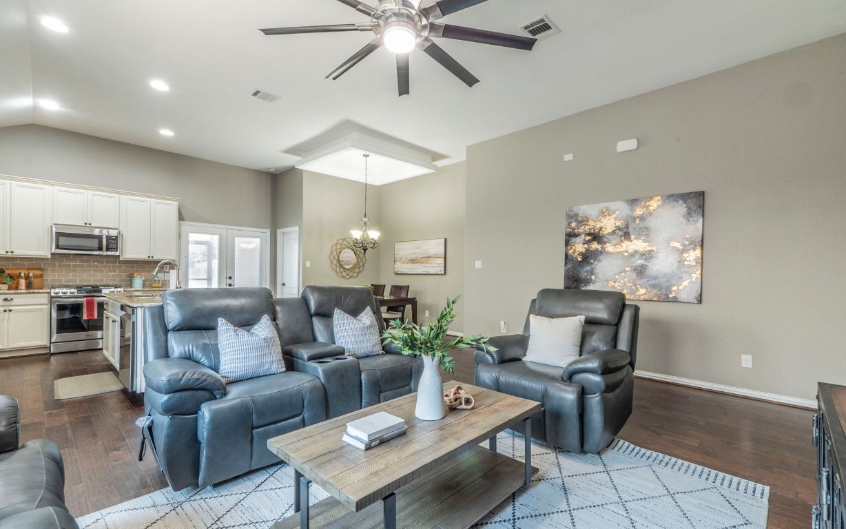 105 Penna Lane Georgetown, TX 78628 - Photo 3 of 39 a living room with furniture and a chandelier