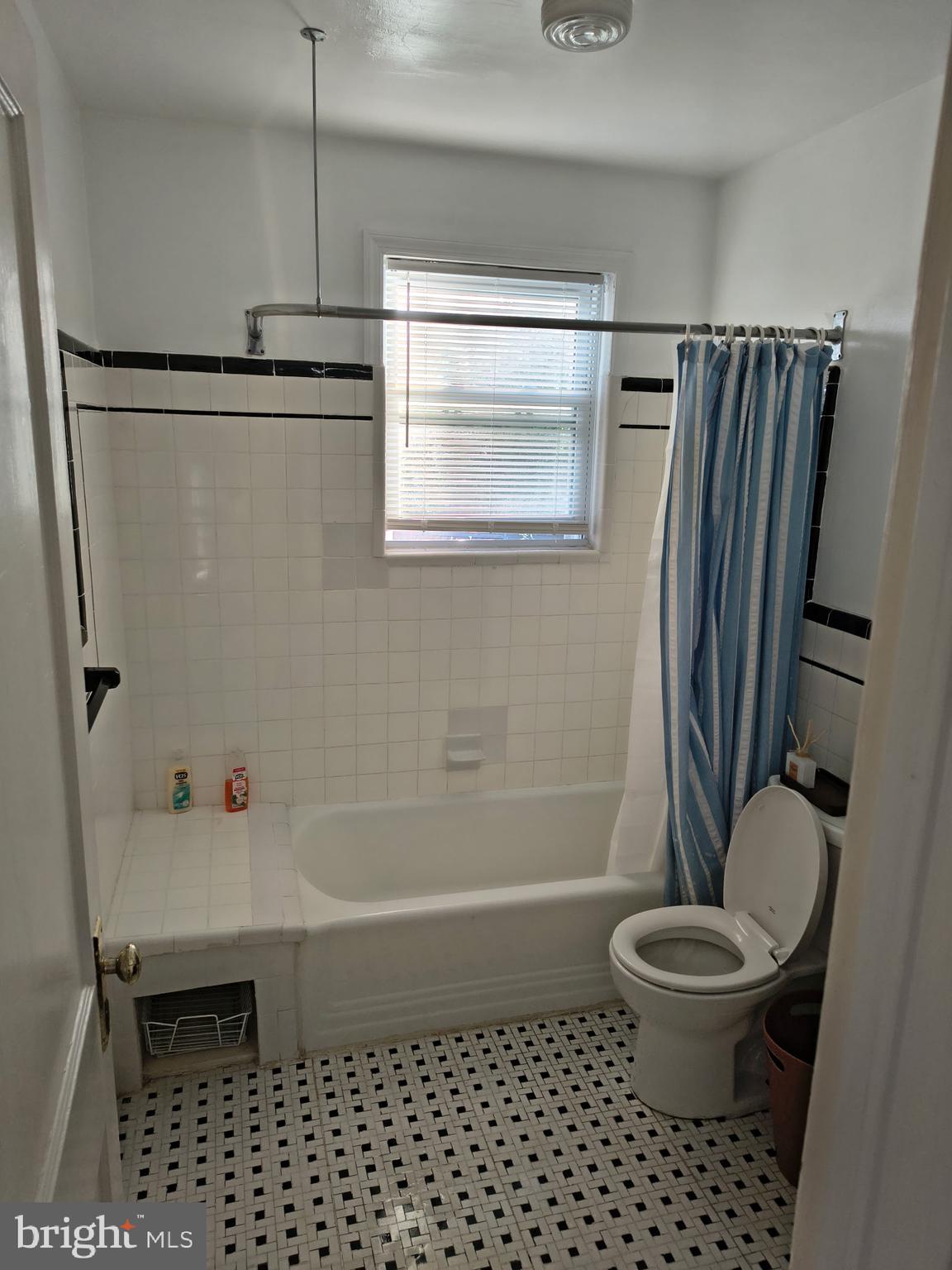 9316 Sudbury Road Silver Spring, MD 20901 - Photo 6 of 19 a bathroom with a sink toilet and shower