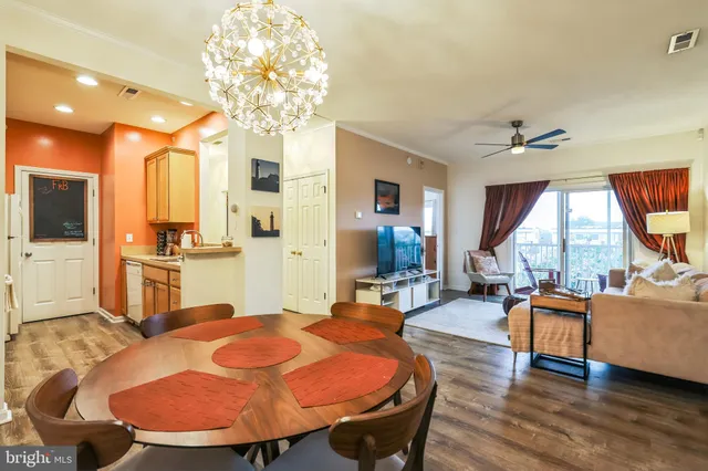 a very nice looking dining room with a large window table and chairs